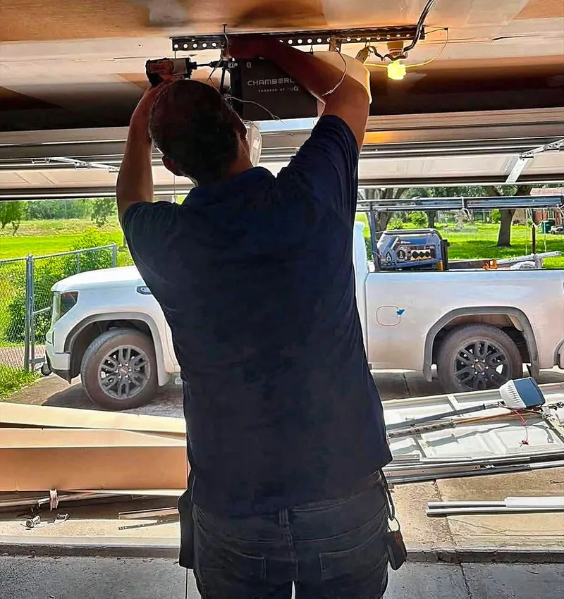 AV Garage Door technician installing a Chamberlain garage door opener